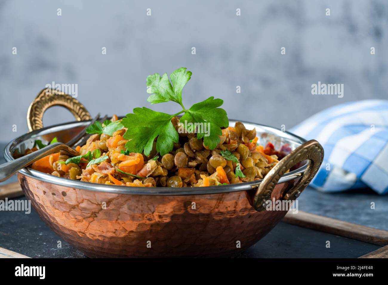 Green lentils stew with white wine, Serrano ham and smoked paprika