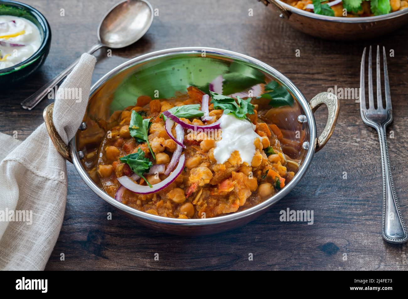Chickpea curry with red onion raita Stock Photo Alamy