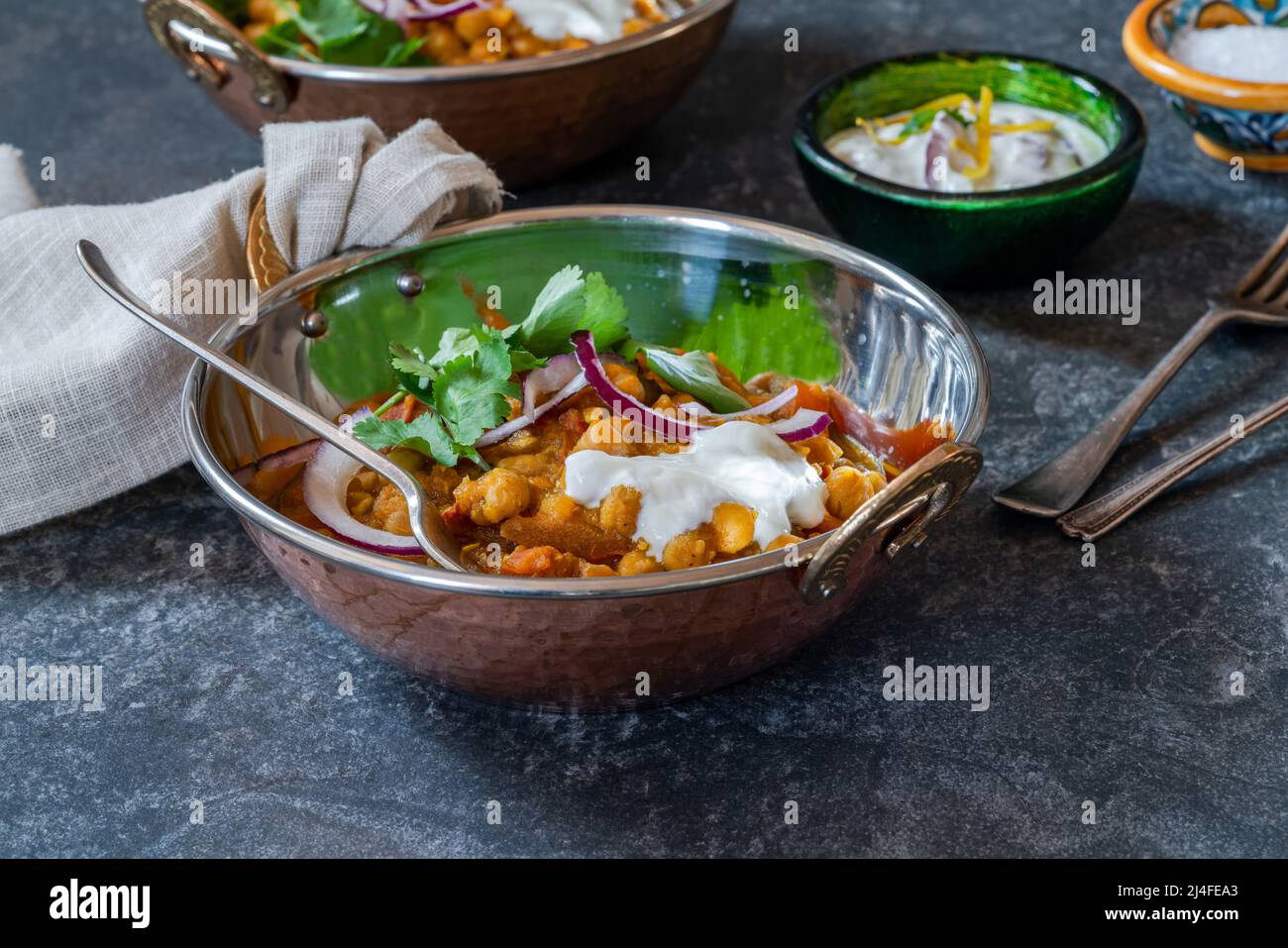 Chickpea curry with red onion raita Stock Photo Alamy