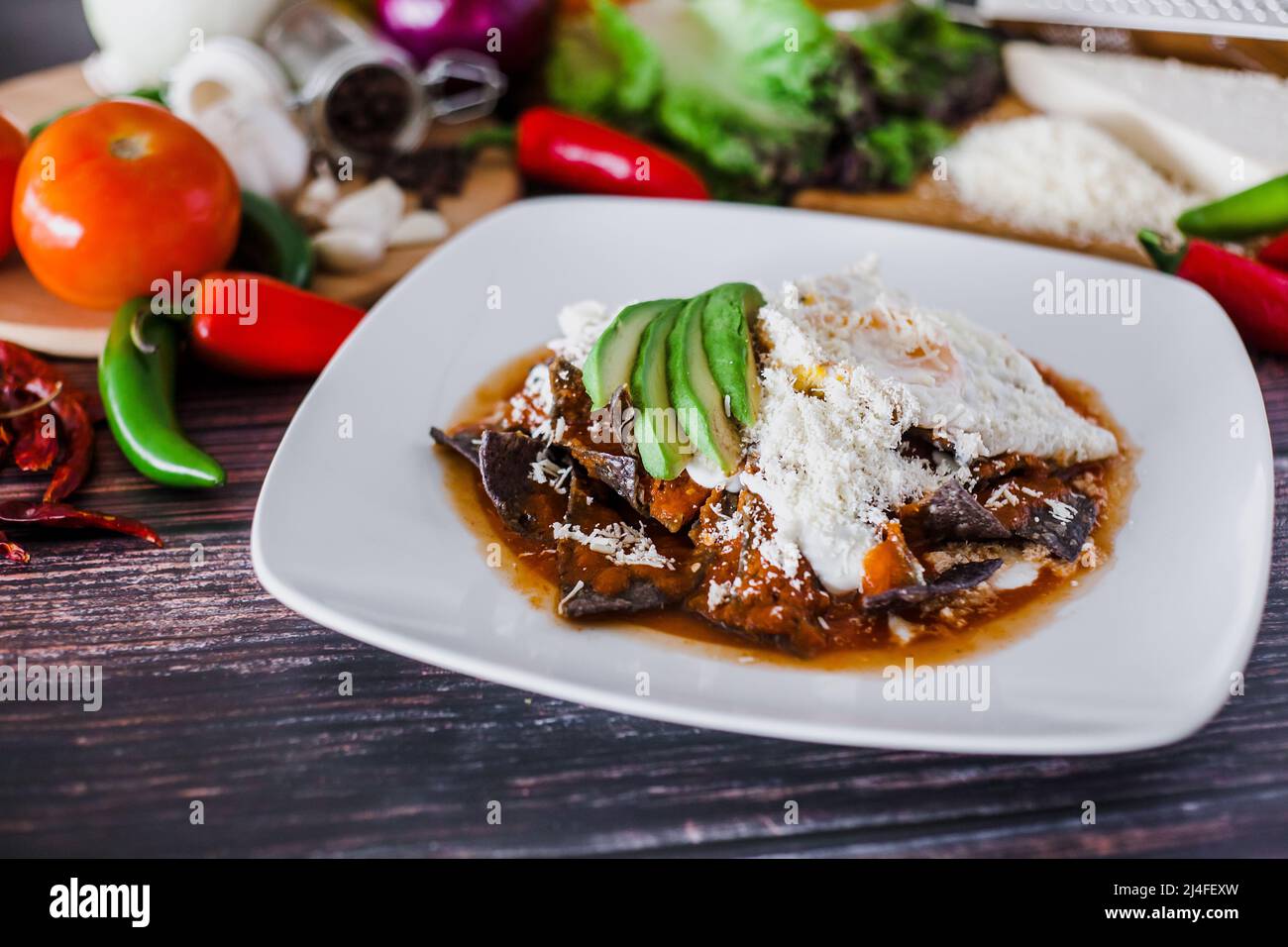 mexican red chilaquiles food with nachos, chicken, egg and cheese traditional breakfast in Mexico Stock Photo