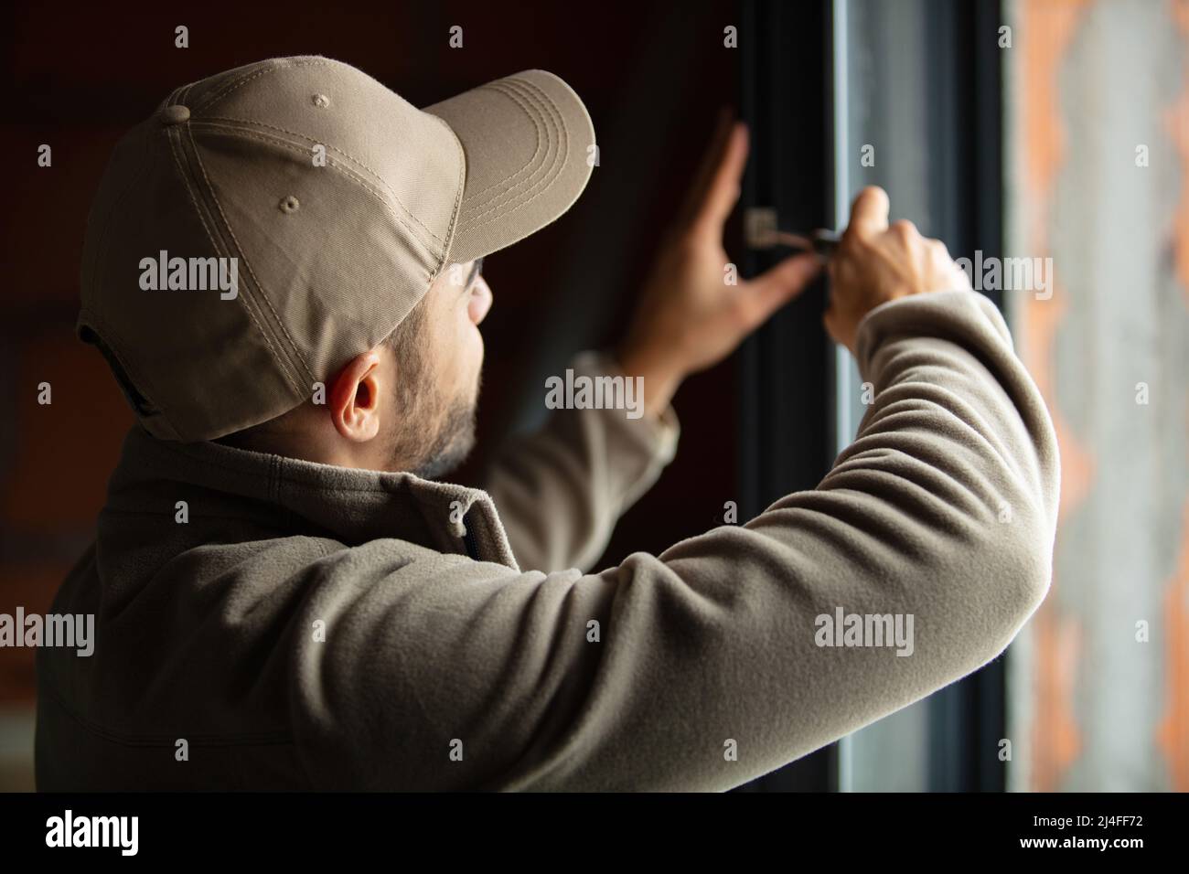 handsome young man installing bay window in a new house Stock Photo