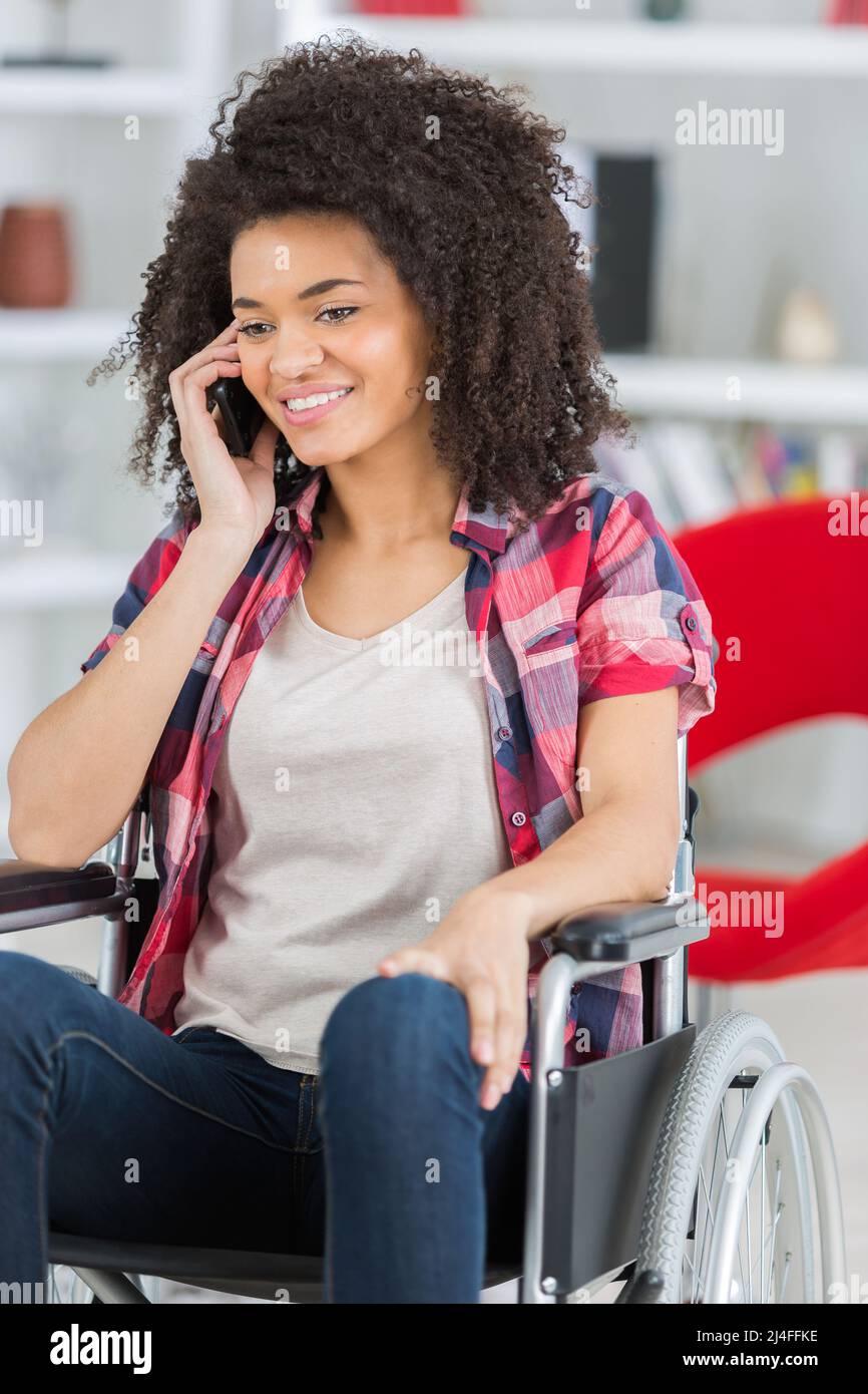 happy young disabled woman in wheelchair making call Stock Photo - Alamy