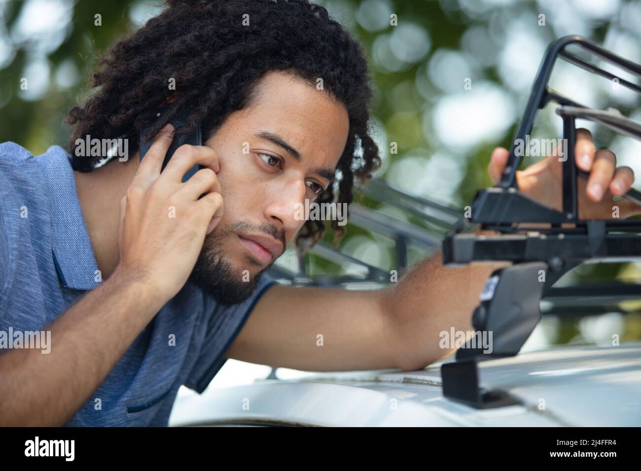 vehicle rack transportation concept young man installing car racks