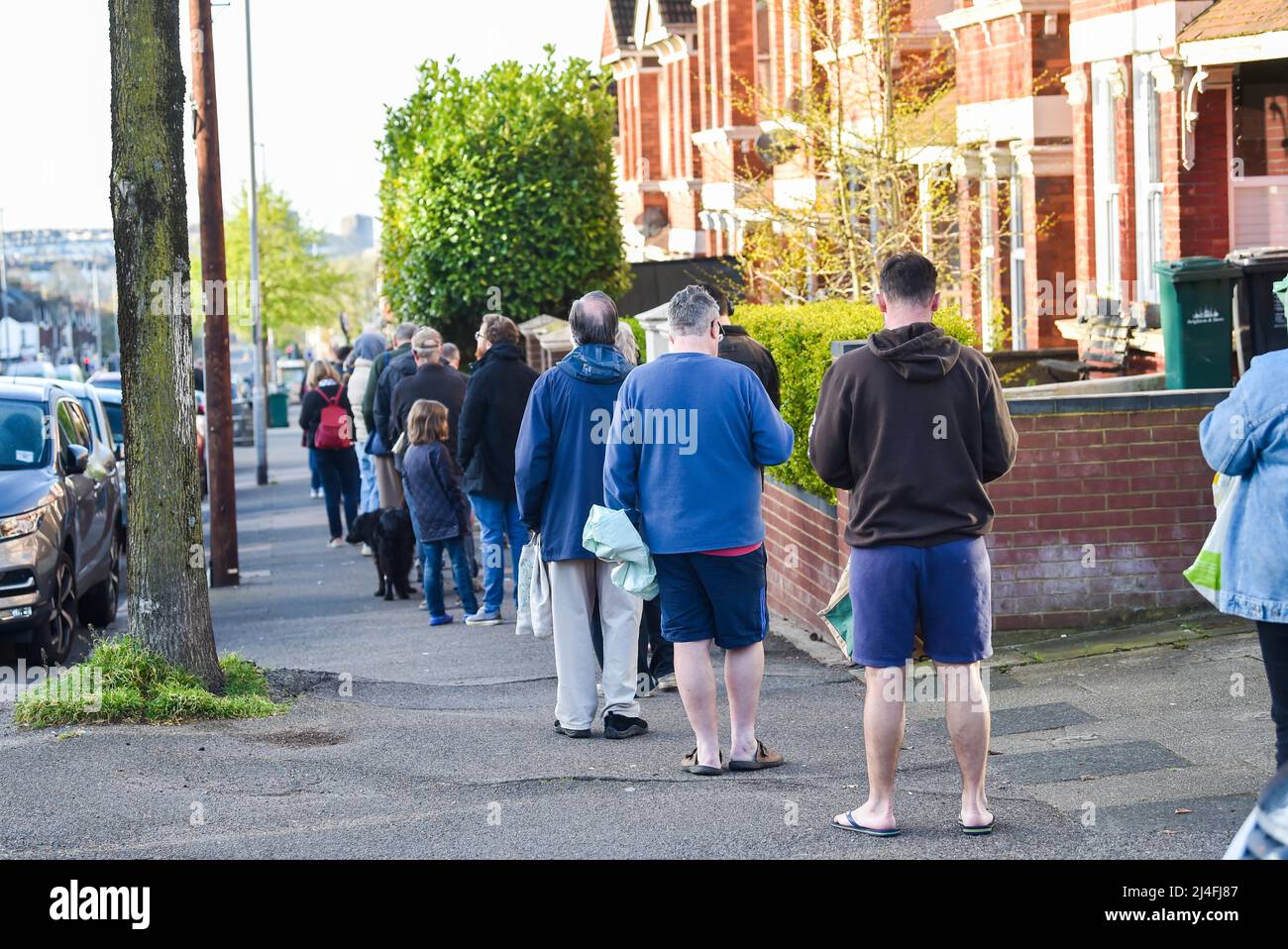 Brighton UK 15th April 2022 - A large queue outside Ravens Bakery in Brighton on Good Friday morning where they are famous for their hot cross buns with customers coming from miles away to buy them : Credit Simon Dack / Alamy Live News Stock Photo