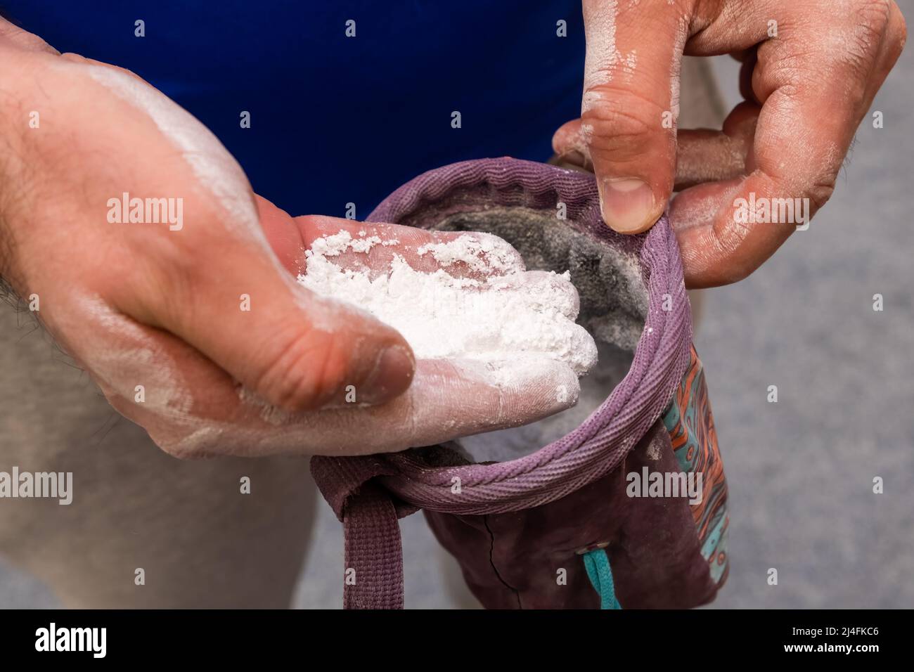 Climber applying chalk powder for rock climbing in bouldering gym Stock