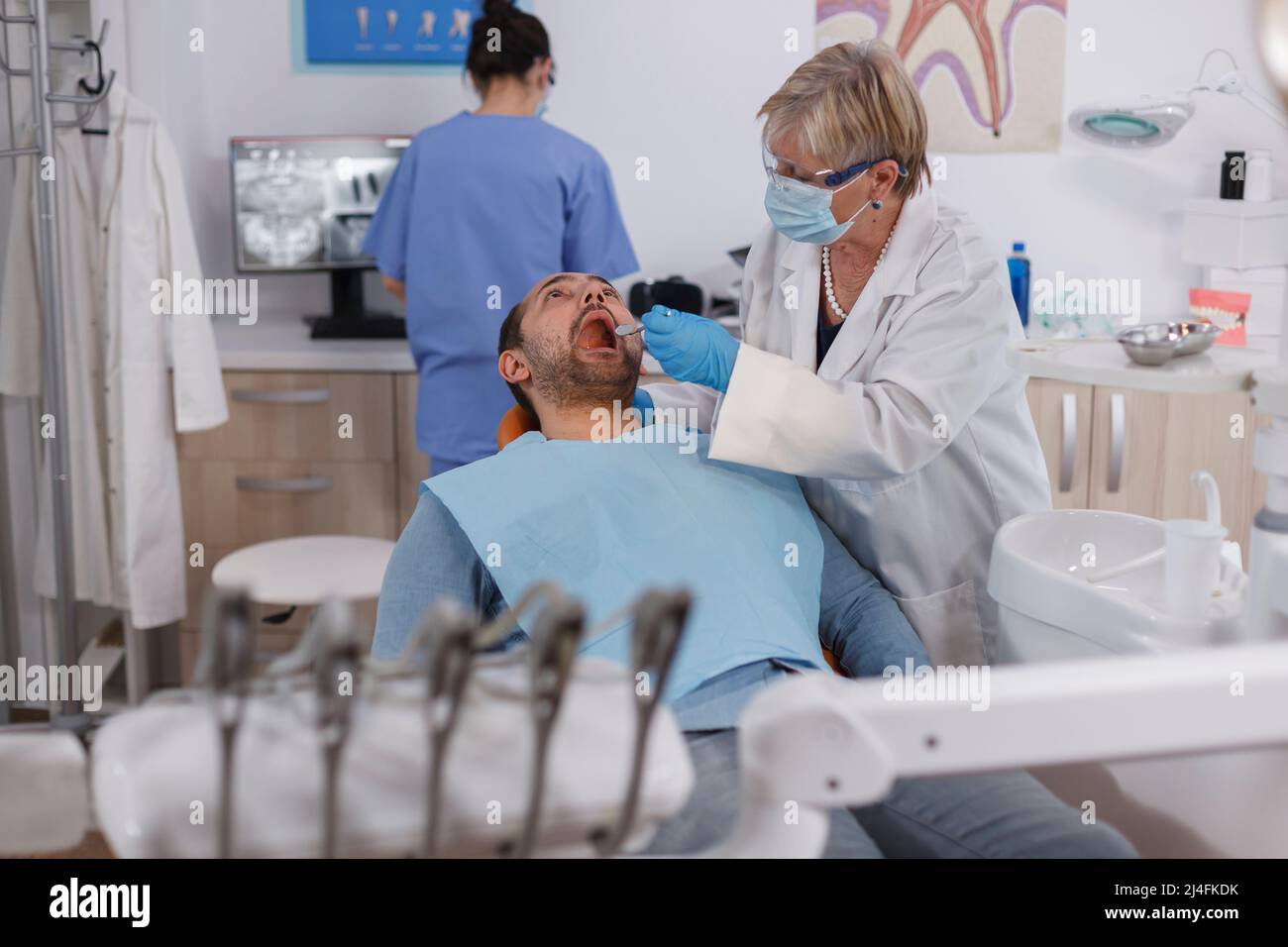 Specialist orthodontist doctor explaining oral hygiene to patient with
