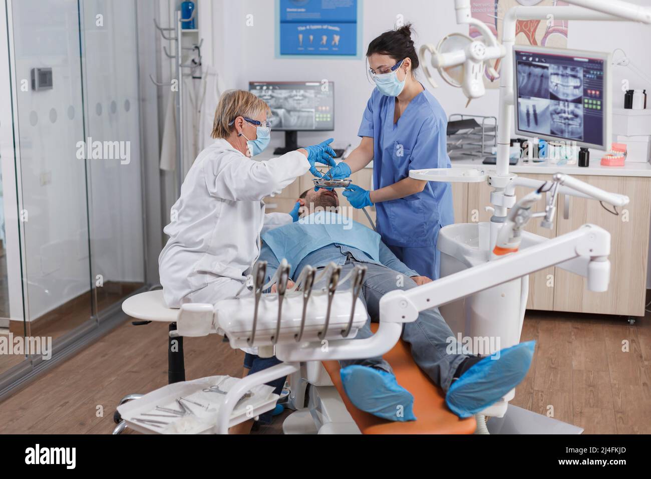Orthodontist team wearing medical face mask during stomatological
