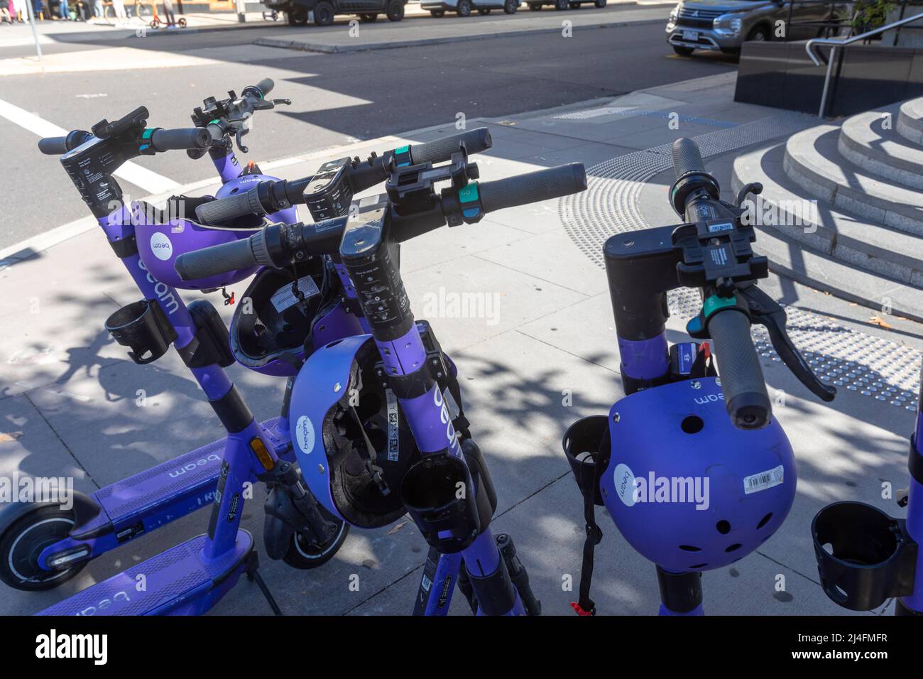 Beam electric e scooters with helmets for hire in Canberra city centre