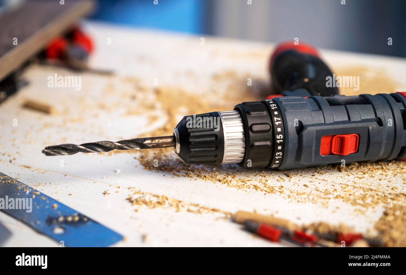 Drill lying on carpenter's table Stock Photo