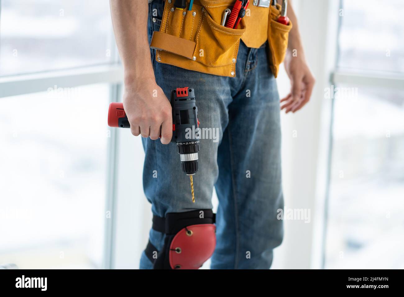 Worker in mounting belt with screwdriver Stock Photo