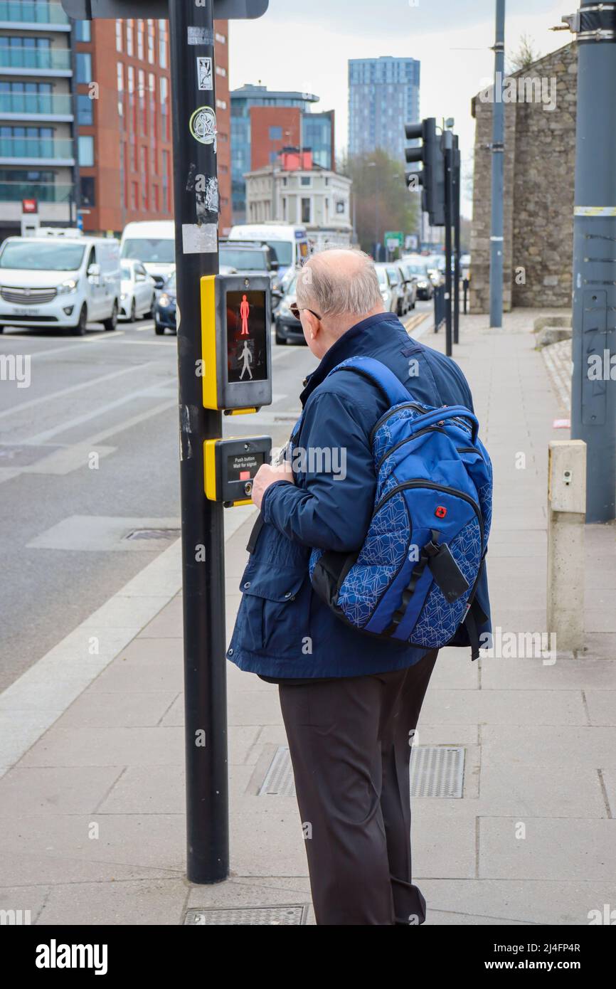Man waiting to cross the road / The Strand, Liverpool Stock Photo