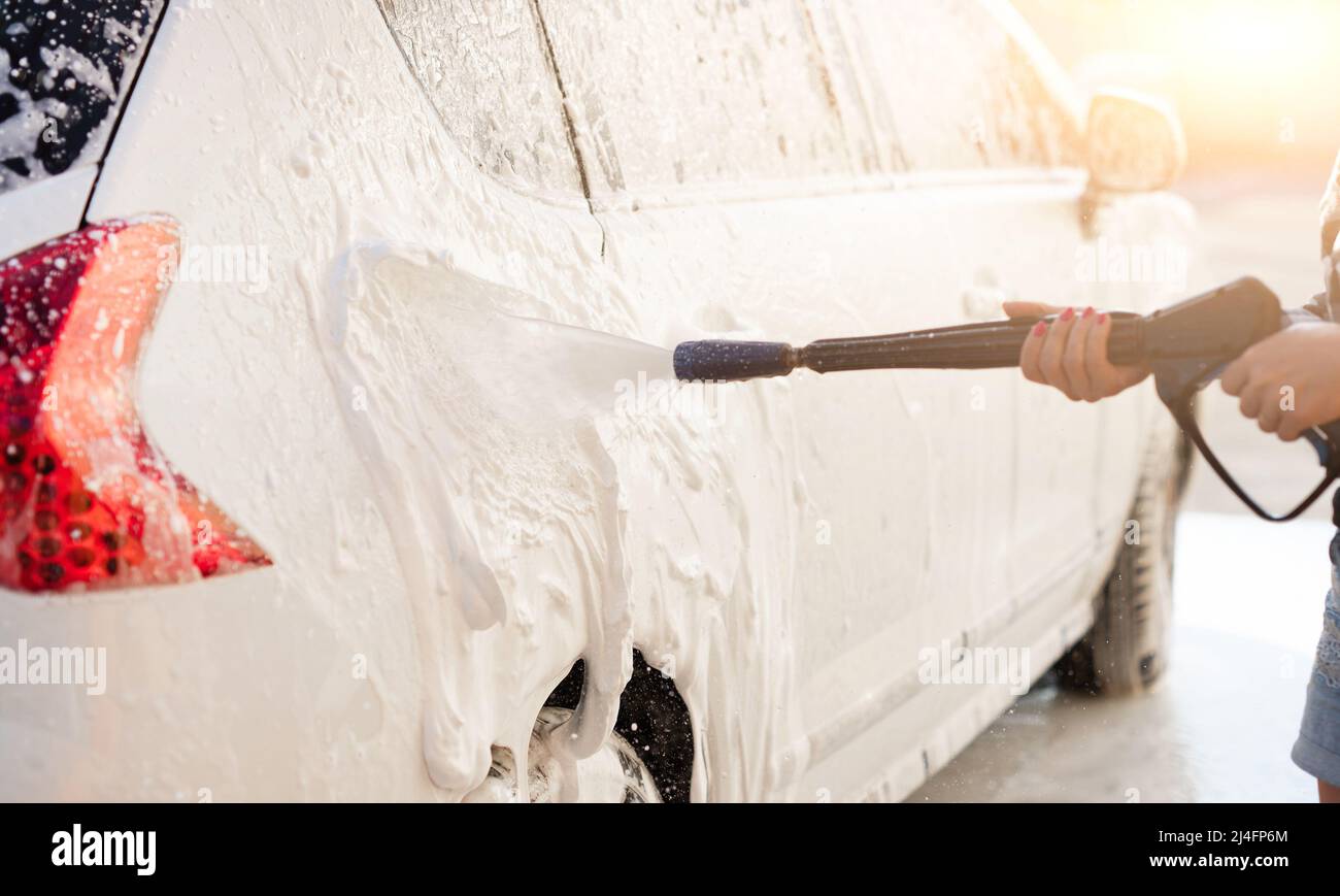 Cleaning car using active foam. Man washing his car on self car-washing  Stock Photo - Alamy