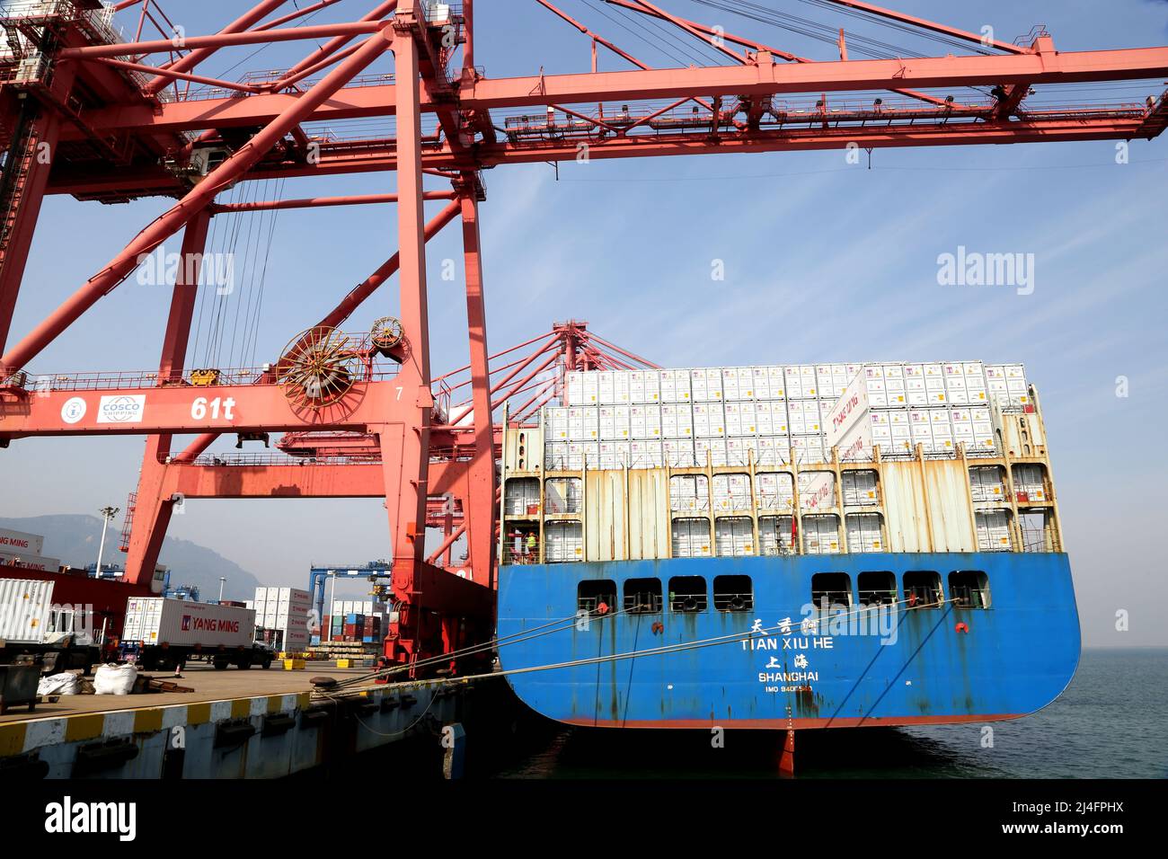 LIANYUNGANG, CHINA - APRIL 15, 2022 - An ocean-going freighter loads ...