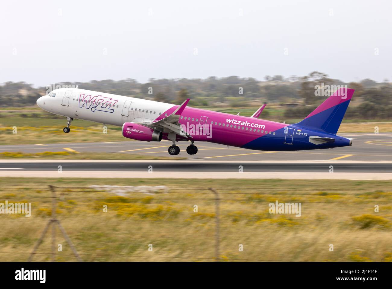 Wizz Air Airbus A321-231 (REG: HA-LXT) lifting off from runway 13, destination: Warsaw, Poland. Stock Photo