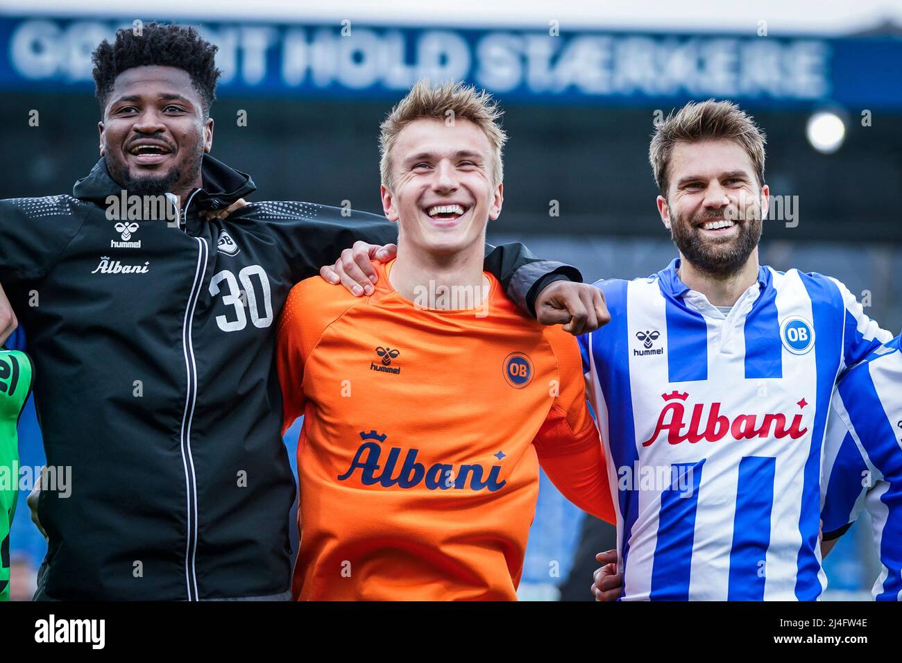 Odense, Denmark. 14th Apr, 2022. Sayouba Mande, Hans Christian Bernat and Jorgen Skjelvik (L-R) of OB celebrate with the fans after the 3F Superliga match between Odense Boldklub and Vejle Boldklub at Nature Energy Park in Odense. (Photo Credit: Gonzales Photo/Alamy Live News Stock Photo