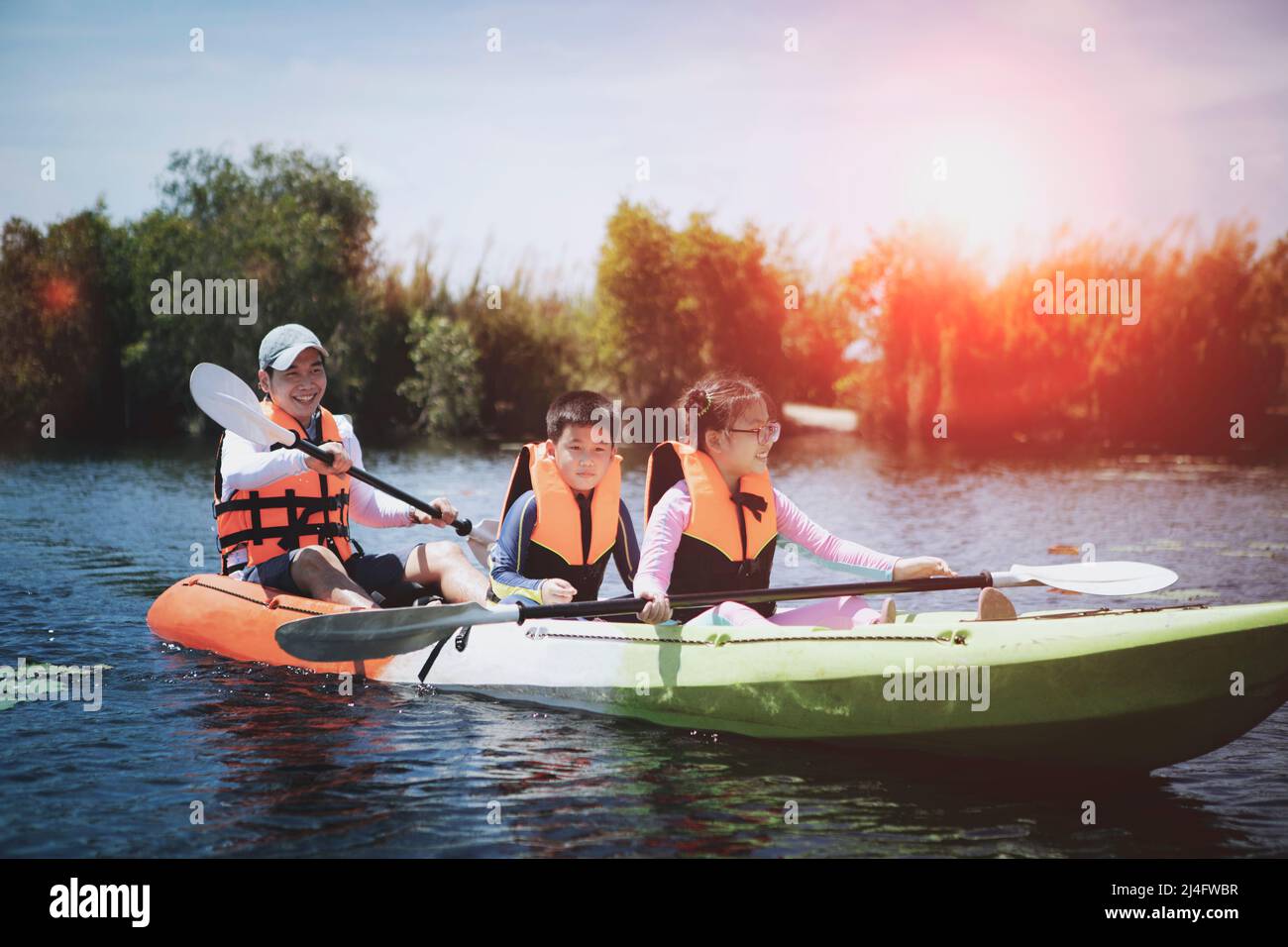 asian family sailing kayak boat in fresh water lake Stock Photo