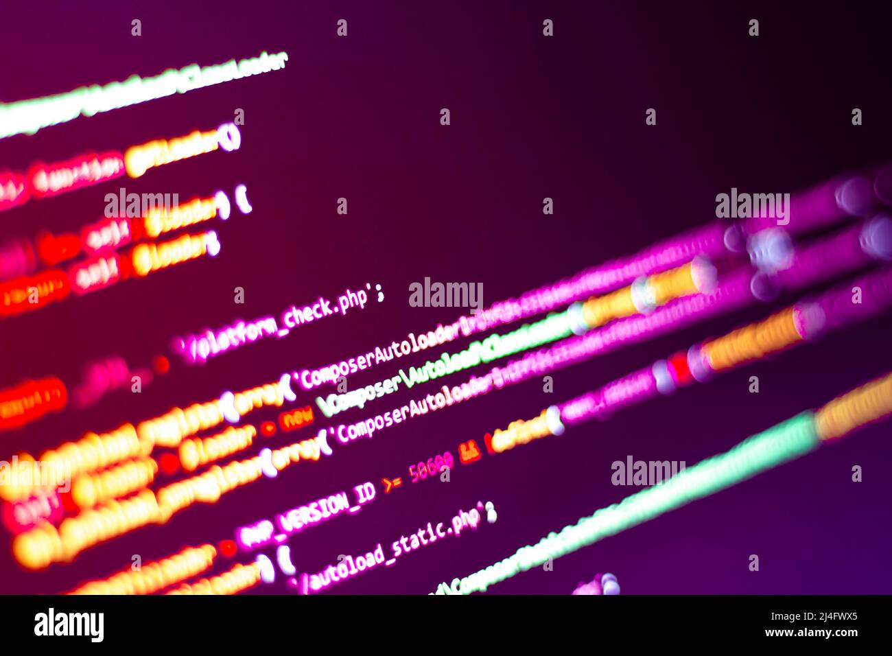 The software developer does the coding. Abstract code screen for use as a background. The programmer does web coding. Selective focus Stock Photo
