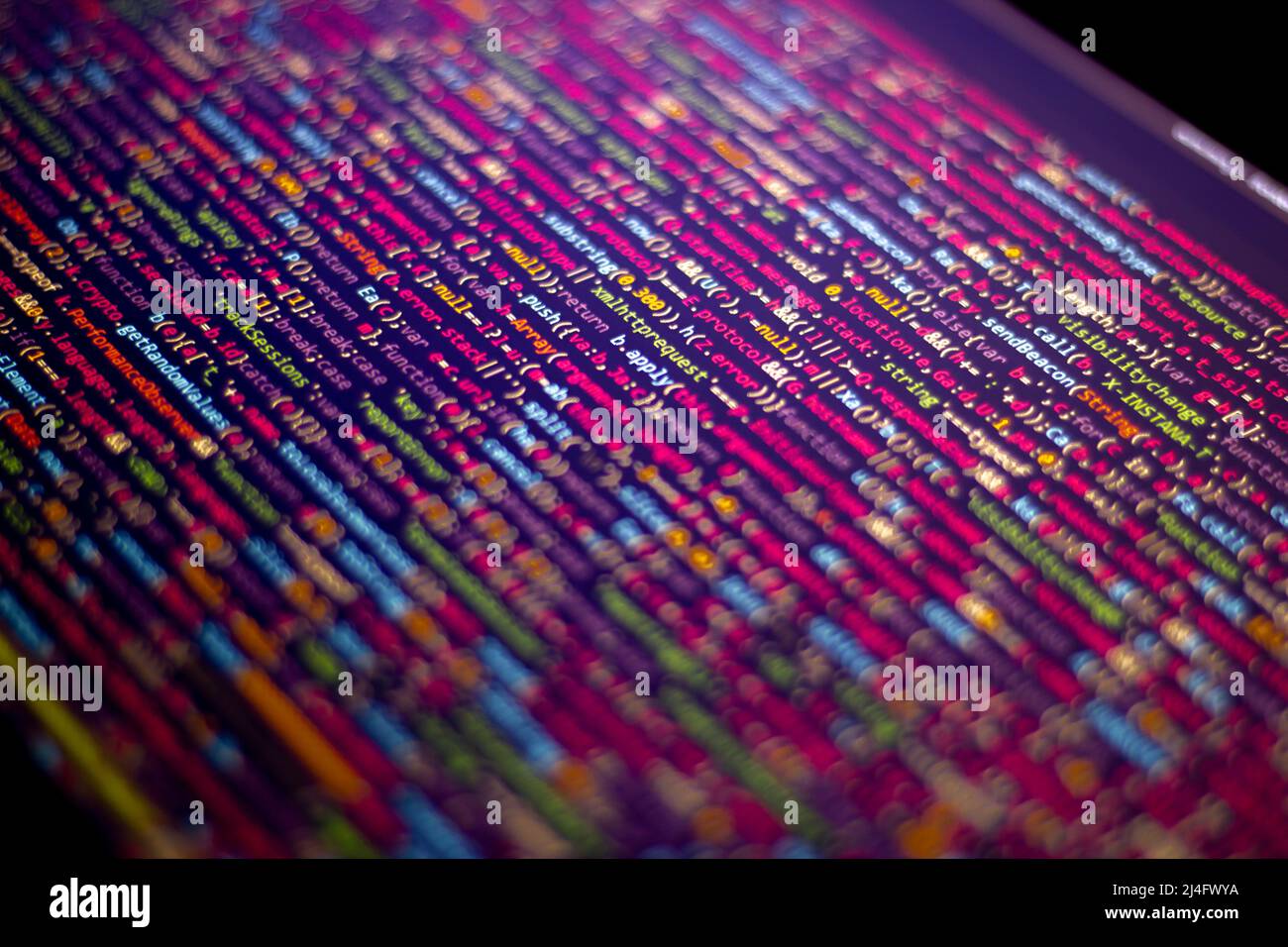 The software developer does the coding. Abstract code screen for use as a background. The programmer does web coding. Selective focus Stock Photo