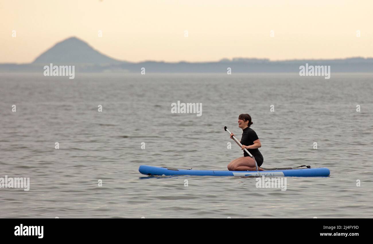 Portobello, Edinburgh, Scotland, UK. 15th April 2022. Dull Good Friday for those out on their paddleboards on the Firth of Forth, temperature 10 degrees centigrade. Credit: Scottishcreative/alamy live news. Stock Photo