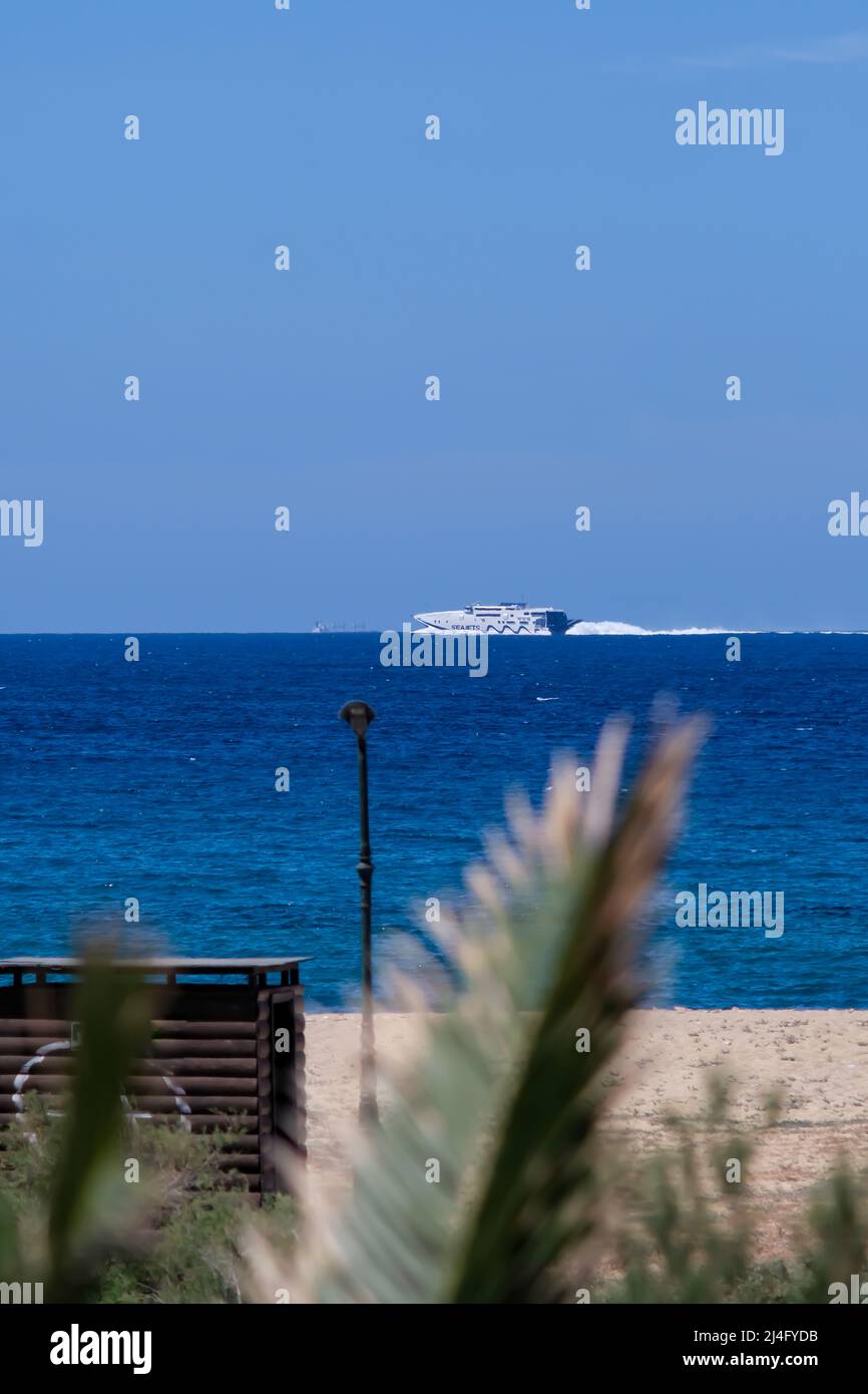 Ios, Greece May 16, 2021 A ferry boat passing in front of the