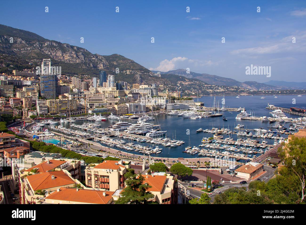 Panoramic aerial view of Monaco and Port Hercule, sweeping views of the city, mountains and harbor, luxury yachts and apartments in La Condamine distr Stock Photo