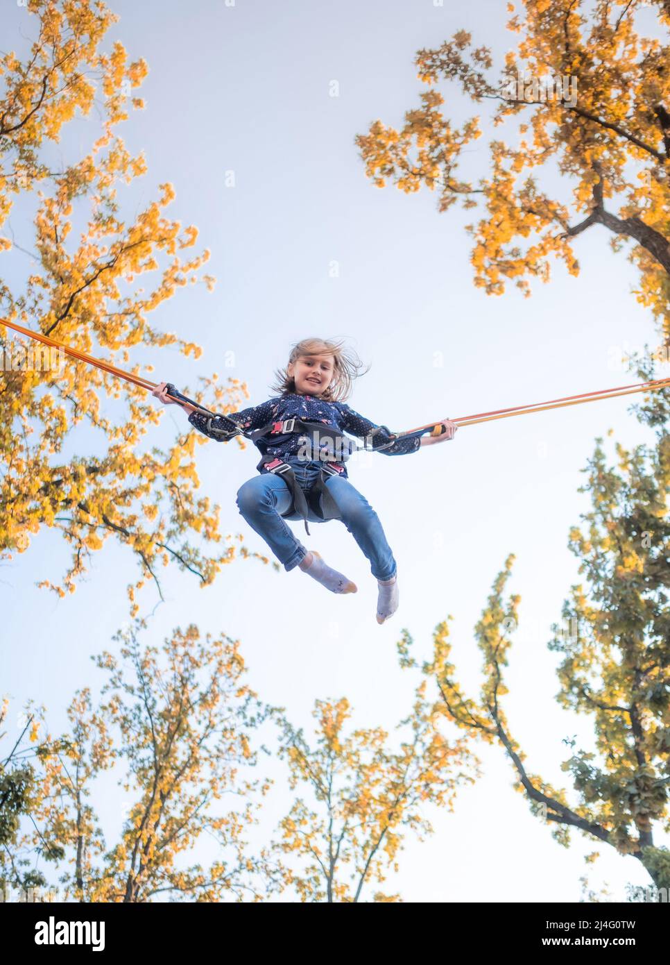 Little girl on trampoline jumping ropes Stock Photo Alamy