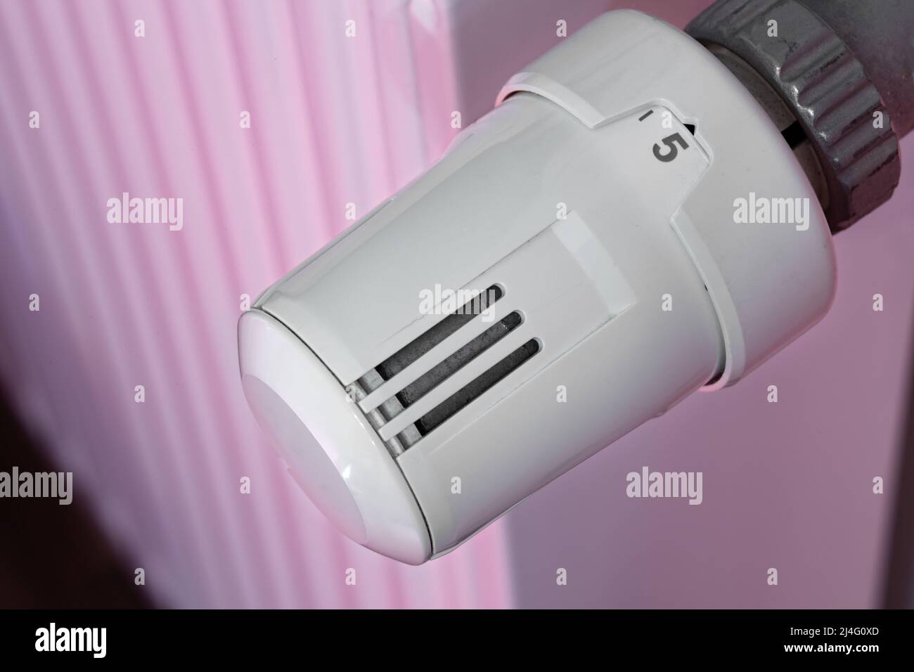 Heating radiator and temperature knob. The temperature is at the highest level of 5. Warmth concept, saving concept. Stock Photo