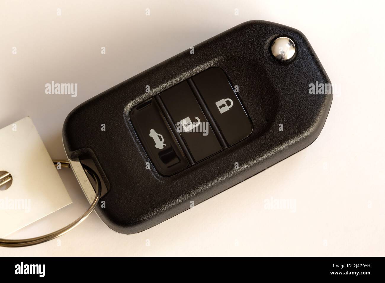 Car key with auto lock, unlock and trunk buttons on isolated white background. Stock Photo