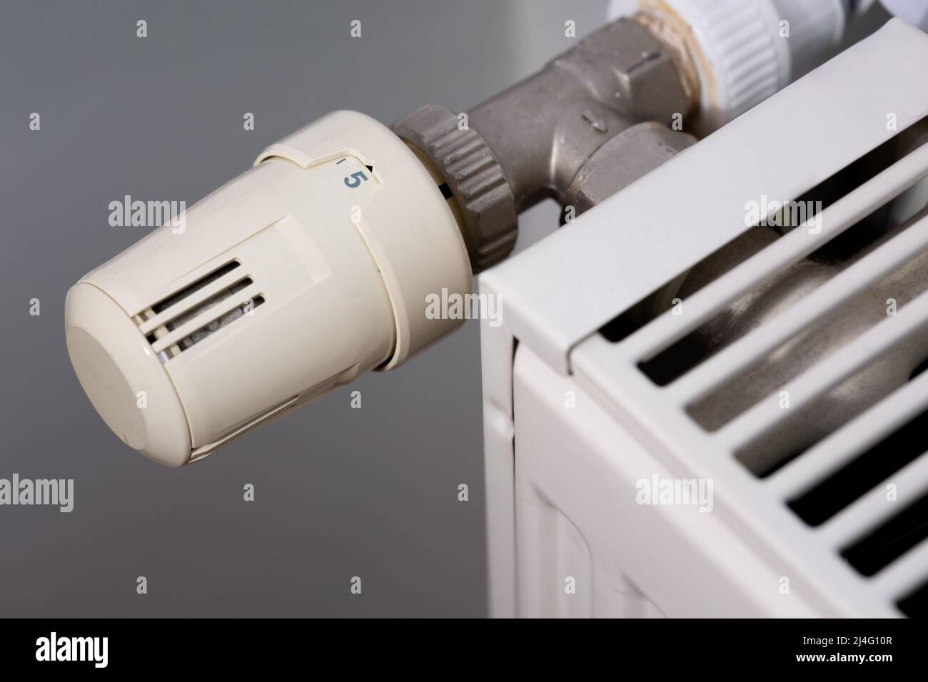Heating radiator and temperature knob. The temperature is at the highest level of 5 Stock Photo