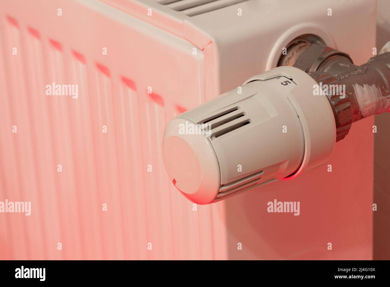 Water heating economy concept - radiator thermostat with red