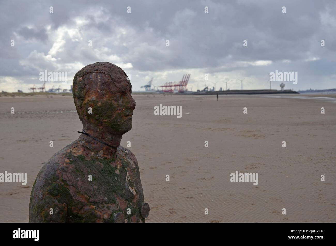 Statues on Crosby Beach in Merseyside, part of the Another Place installation by sculptor and artist Antony Gormley Stock Photo