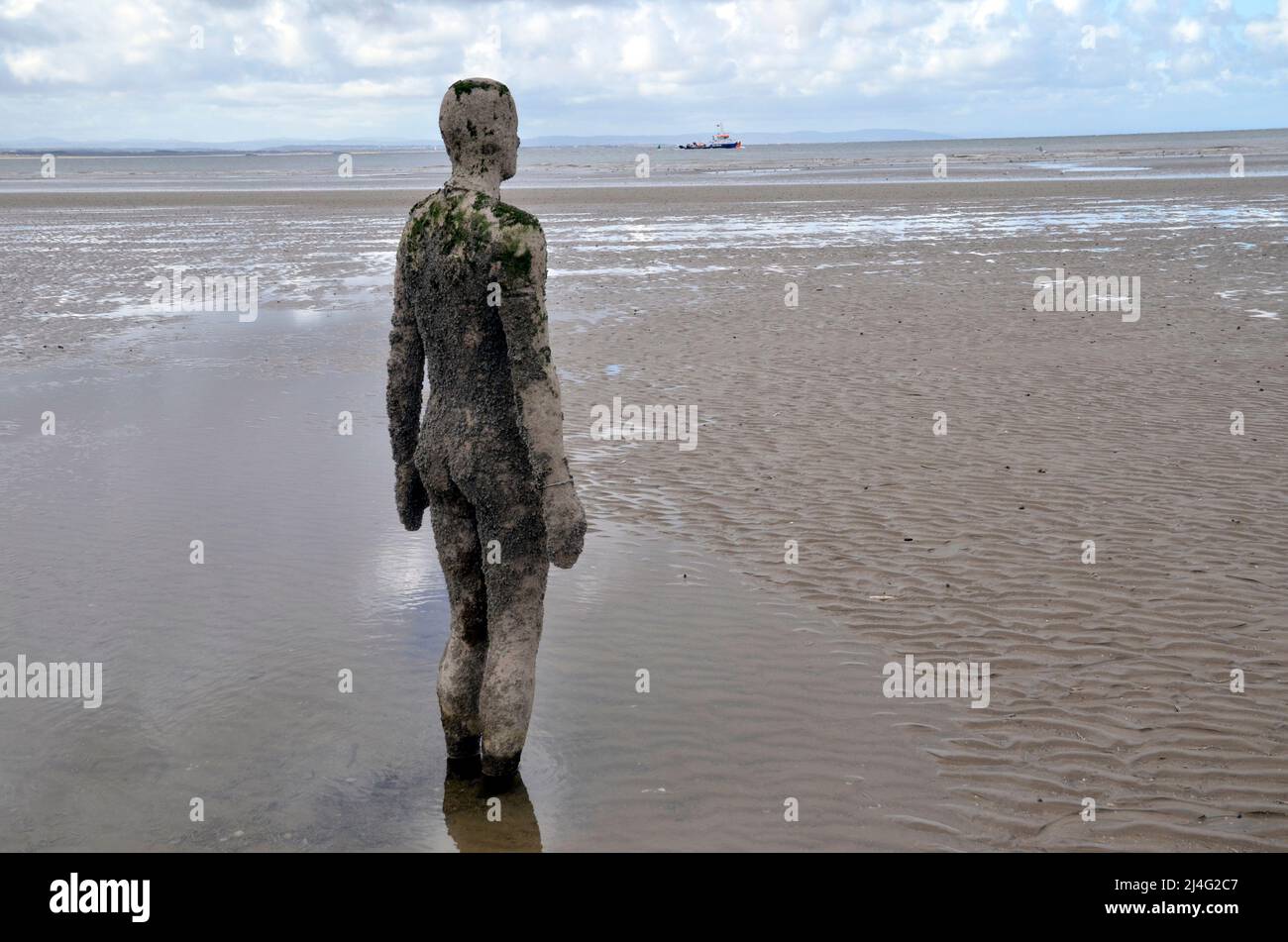 Statues on Crosby Beach in Merseyside, part of the Another Place installation by sculptor and artist Antony Gormley Stock Photo