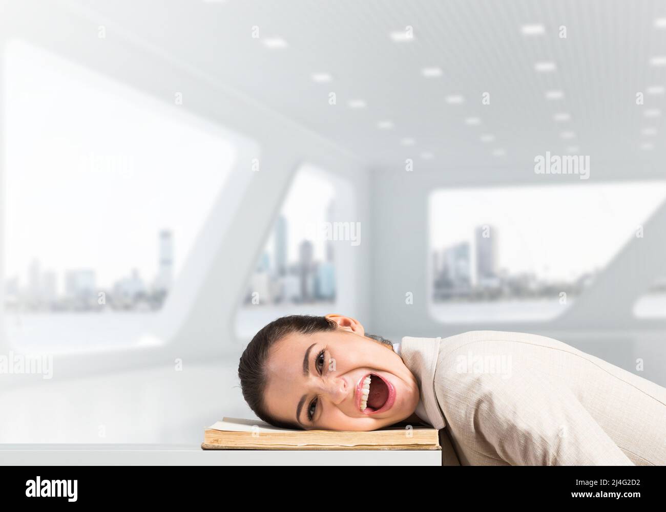 Bored business woman lying on desk Stock Photo