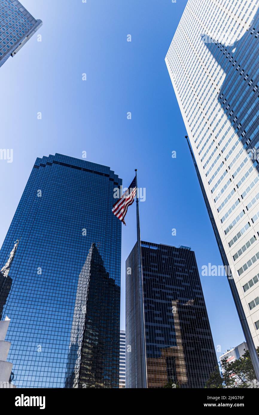 An American flag surrounded by skyscrapers in downtown Dallas Stock Photo