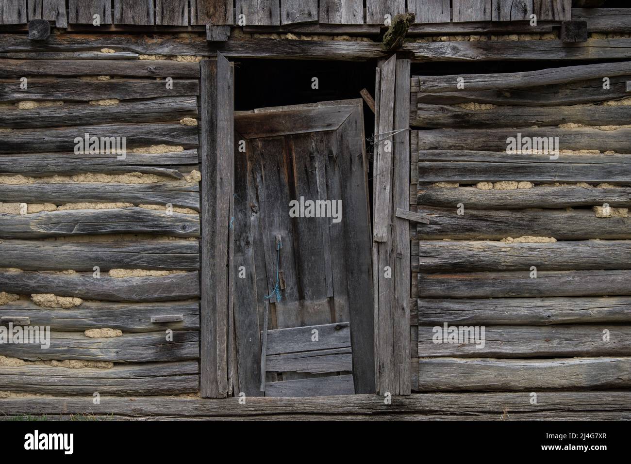 Old wooden rustic doors on rural home wall Stock Photo - Alamy