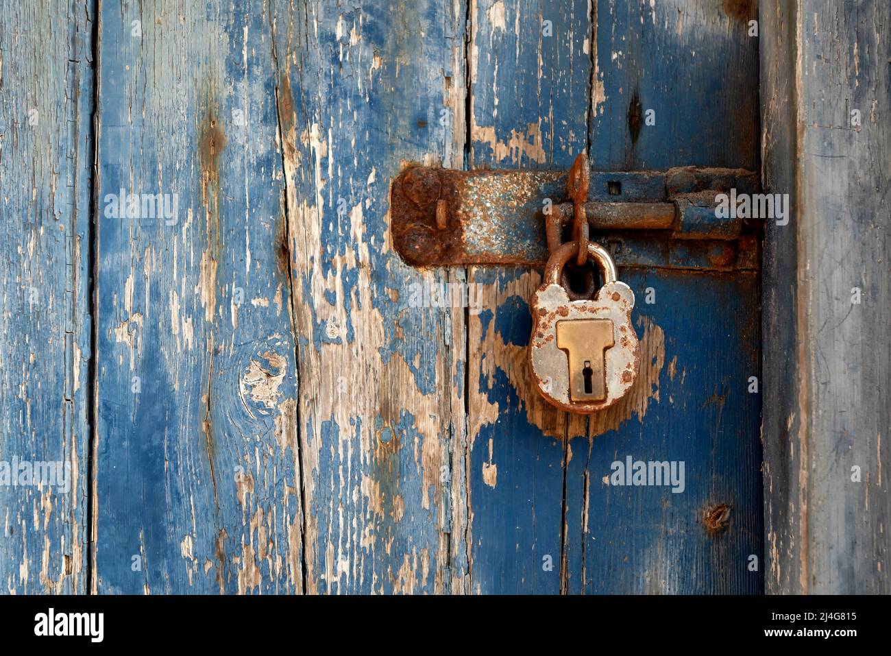 Old blue wooden door with rusty lock Stock Photo