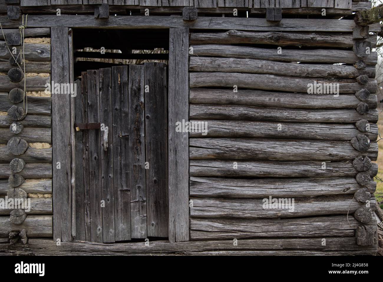 Old wooden rustic doors on rural home wall Stock Photo - Alamy