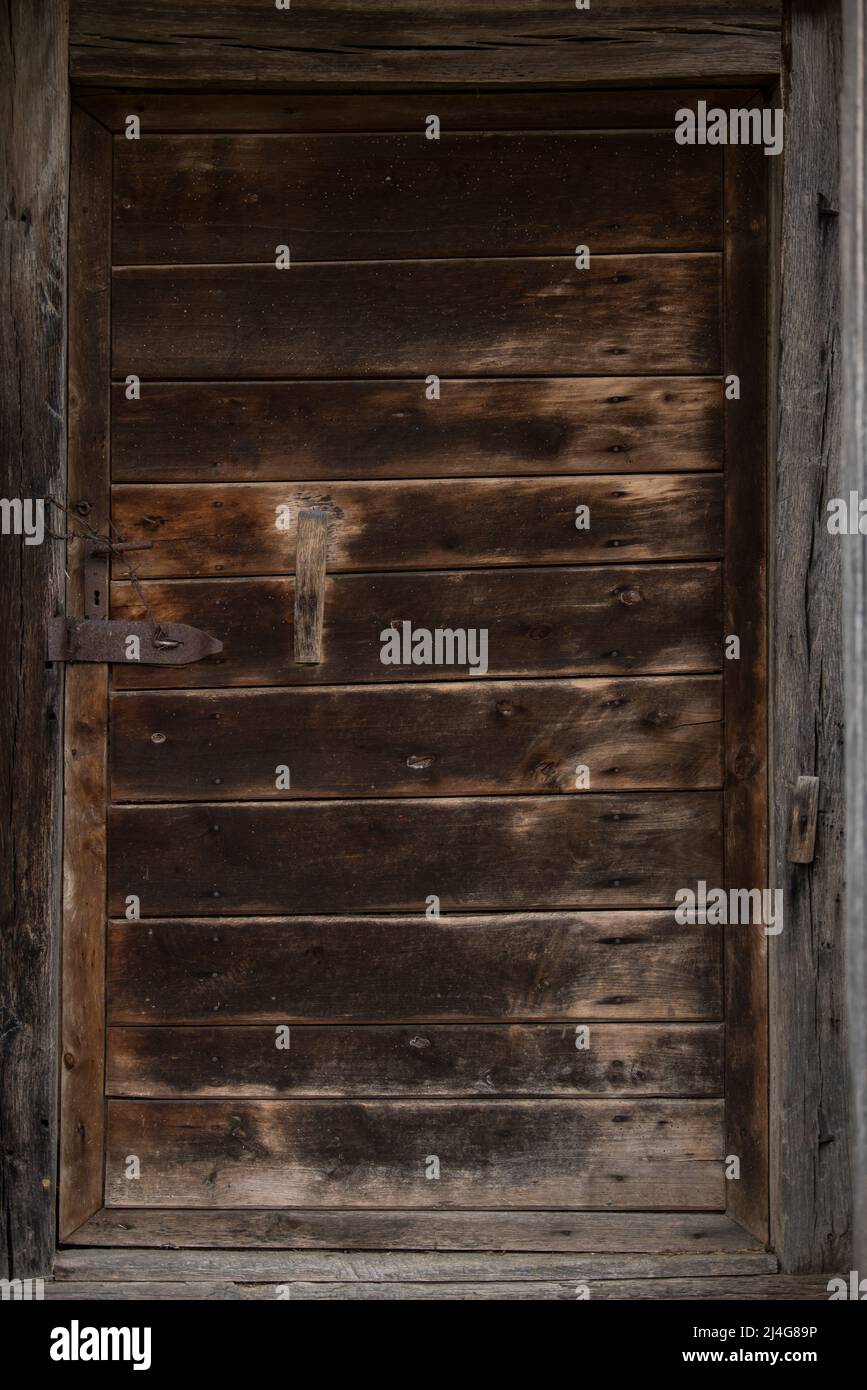 Old wooden rustic doors on rural home wall Stock Photo - Alamy