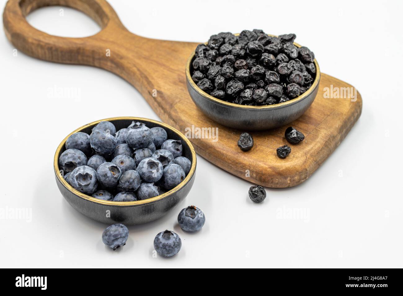 Raw and dried blueberries isolated on white background.Blueberries in