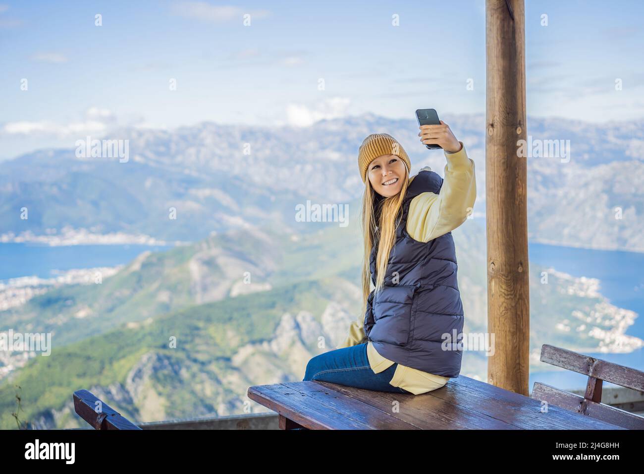 Woman tourist enjoys the view of Kotor. Montenegro. Bay of Kotor, Gulf
