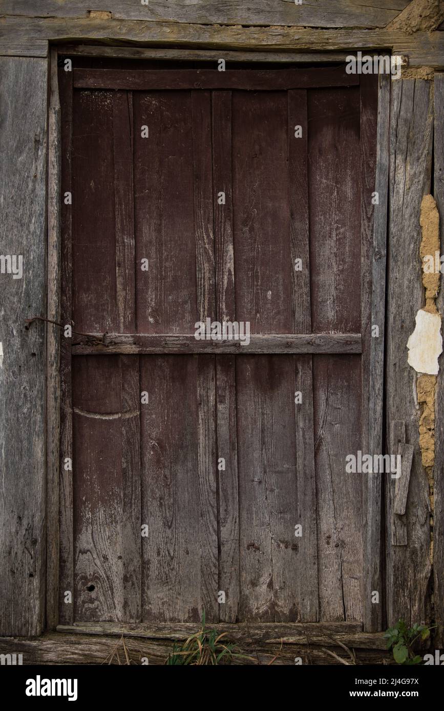 Old wooden rustic doors on rural home wall Stock Photo - Alamy