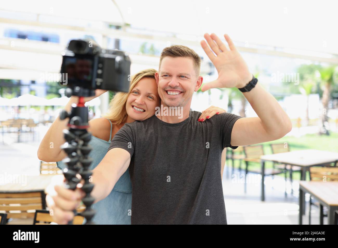 Smiling married couple blogger greets followers on camera Stock Photo ...