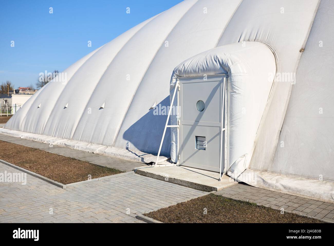 Inflatable air dome stadium. Inflated Tennis air dome or Tennis bubble  arena entrance door into structure equipped with airlock either two sets of  Stock Photo - Alamy