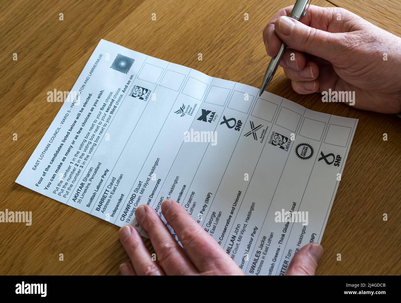 East Lothian, Scotland, United Kingdom, 15th April 2022. Council election ballot paper arrives: a man casts his vote on a postal ballot paper for the Haddington and Lammermuir Ward which arrived today for the local Scottish council elections in May 2022. Parties represented include Scottish Labour, Scottish National Party (SNP), Scottish Conservatives, Scottish Greens, Scottish Liberal Democrats and the Alba Party Stock Photo