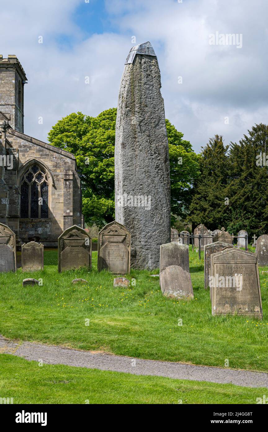 The Monolith of Rudston, a 25-foot tall megalith next to the church of All Saints, Yorkshire, England Stock Photo