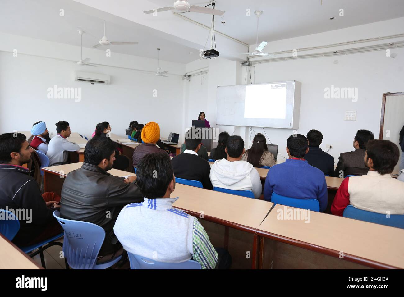 young students in classroom in India with smart board and projector in University lecture room photo Stock Photo