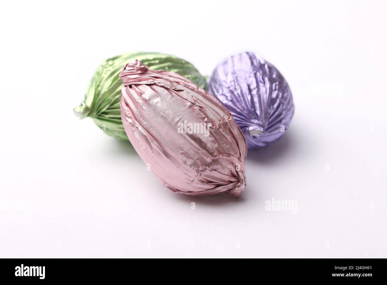 Three pastel colored chocolate Easter eggs Stock Photo Alamy