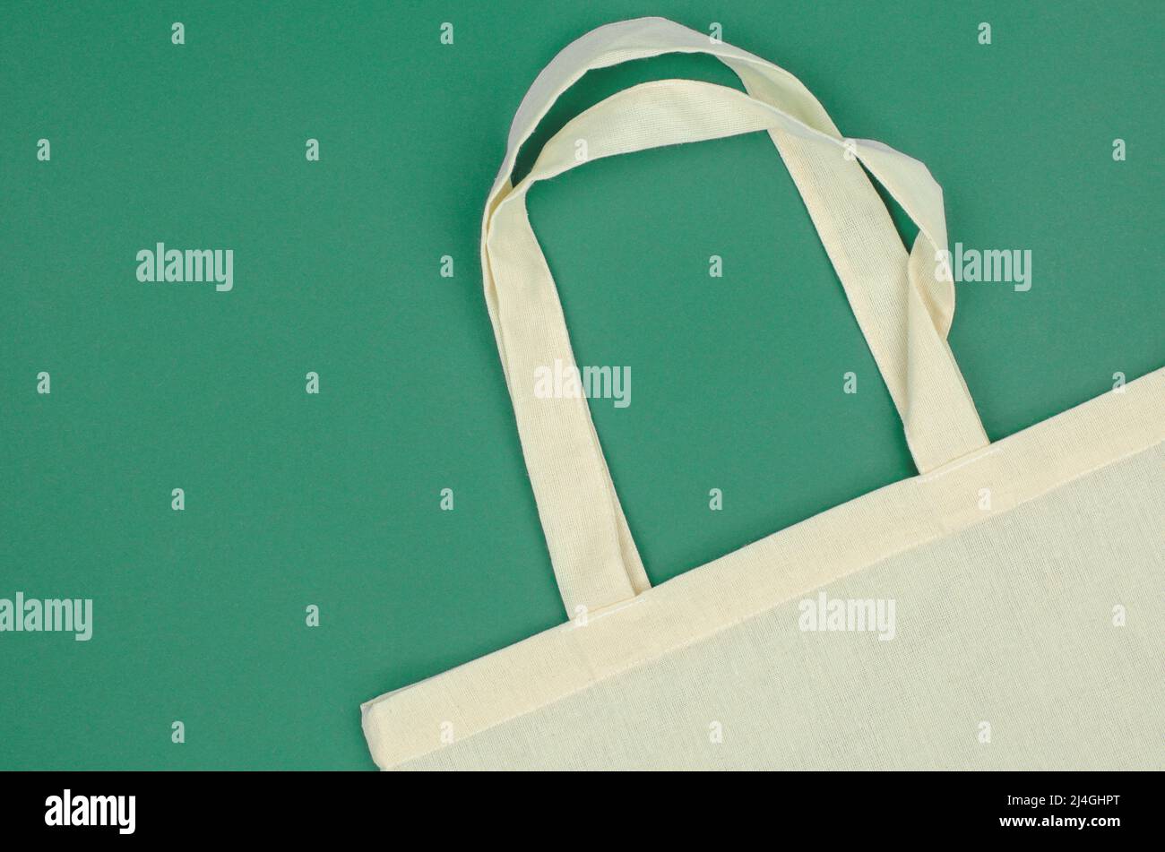 Eco bag made of cotton on a green background. Green products and zero ...