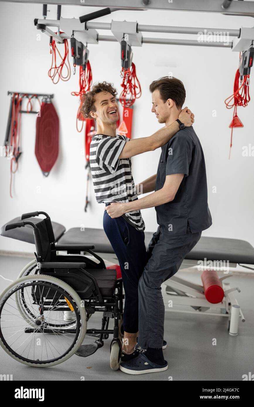Helping a man in a wheelchair hi-res stock photography and images - Alamy