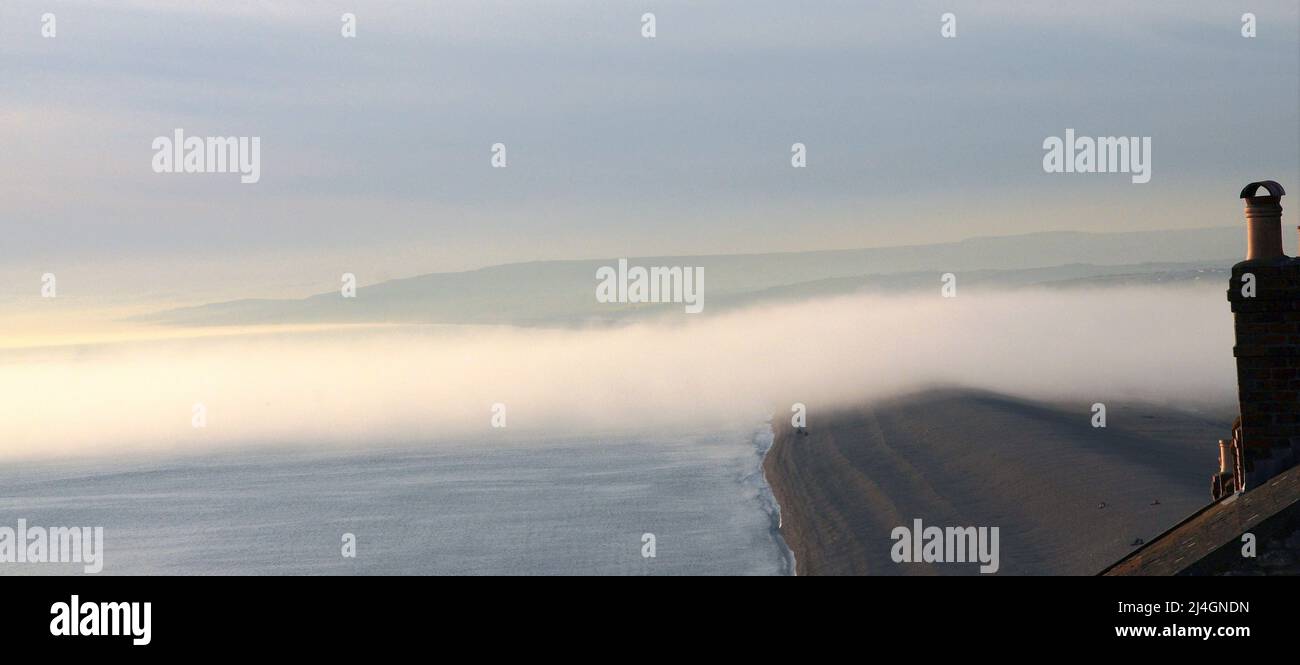Chesil Beach. 14th April 2022. UK Weather. A fog bank drifts, like a